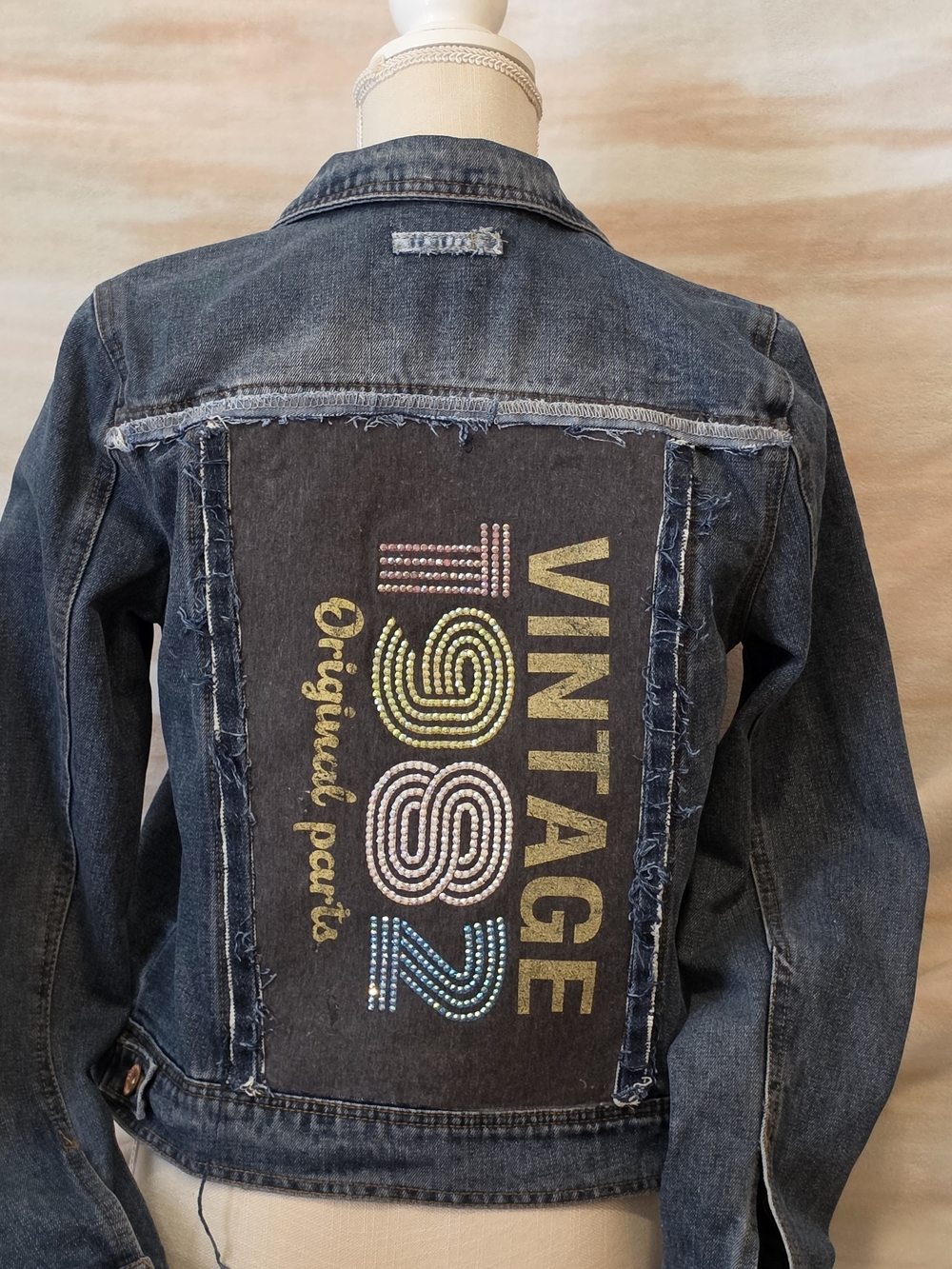 Vintage Blue Denim Jacket with Multicolor Studded 'VINTAGE 1982' Back